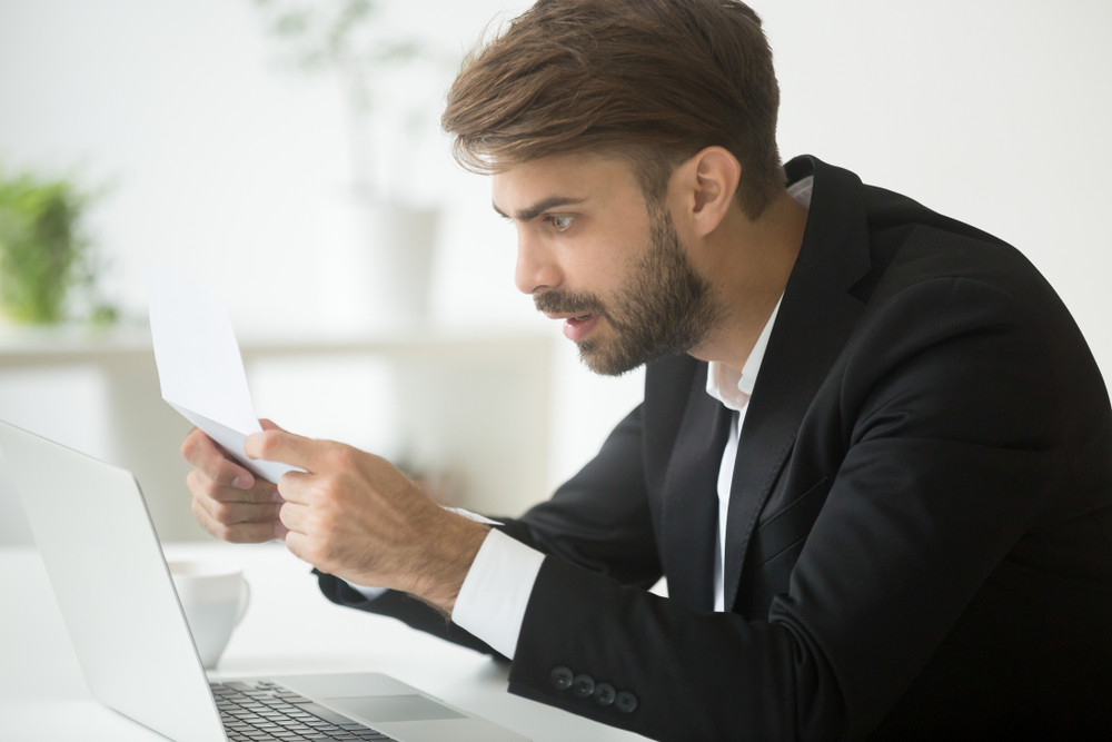 Amazed,Businessman,In,Suit,Feeling,Shocked,By,Reading,Mail,,Surprised